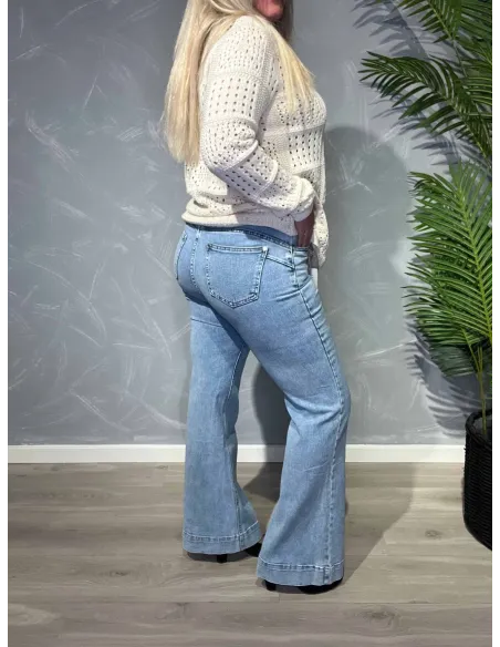 Lyse flared leg jeans fra Karostar vist bagfra på model mod grå baggrund -TIPPY